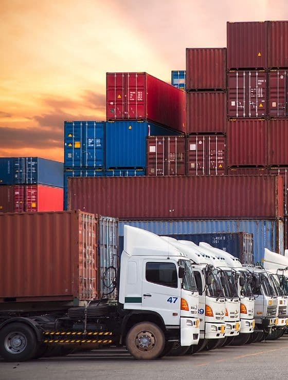 Transport and freight network with trucks and stacked containers.